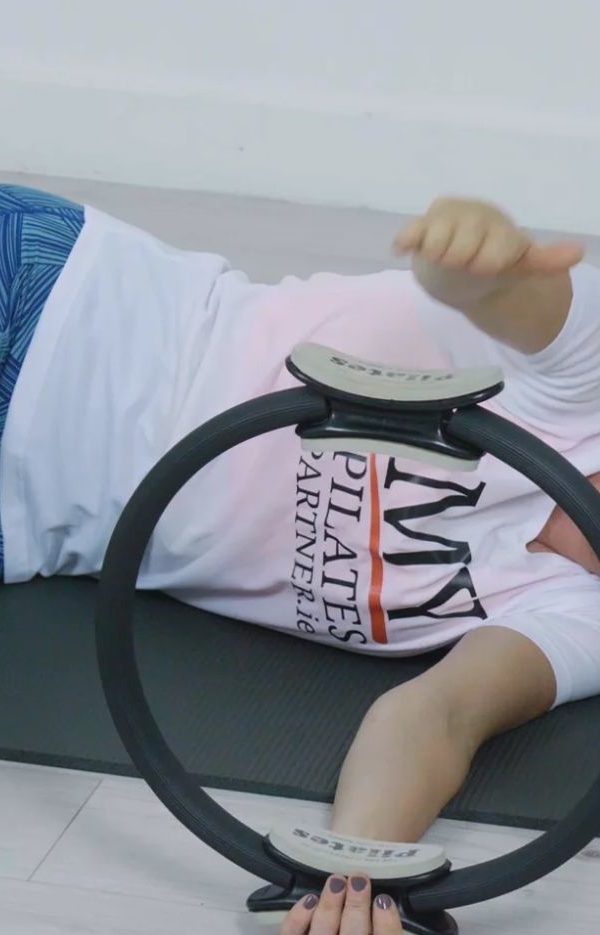 woman exercising with Pilates fitness circle