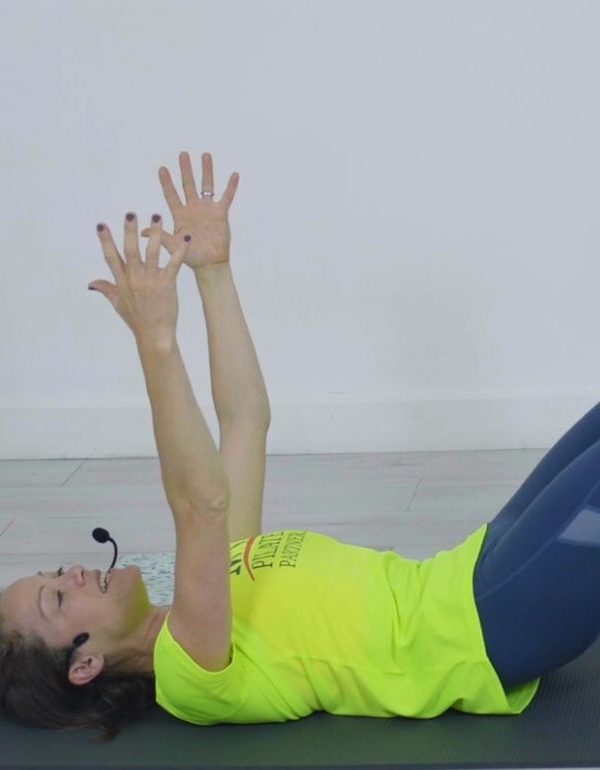 Woman in yellow t-shirt exercising