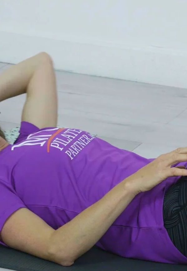 Woman exercising on mat