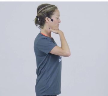 stand tall Pilates posture video grey t-shirt, headphones