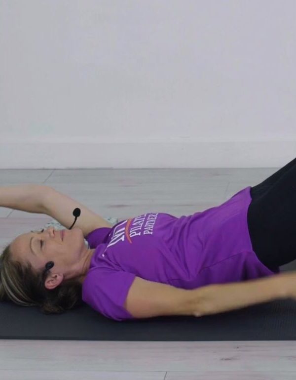 Woman, purple t-shirt, moving arms and exercising